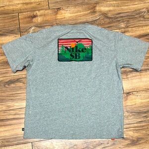 NWOT. Nike SB Gray Short Sleeve Tee with Graphic Design. Men’s size M.